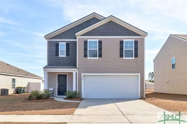 view of front facade with a garage and central AC