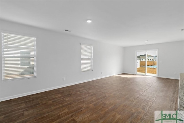 spare room featuring dark hardwood / wood-style flooring