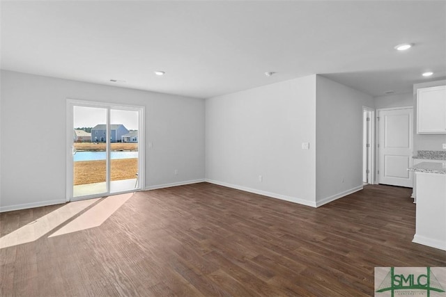 unfurnished living room featuring dark hardwood / wood-style flooring