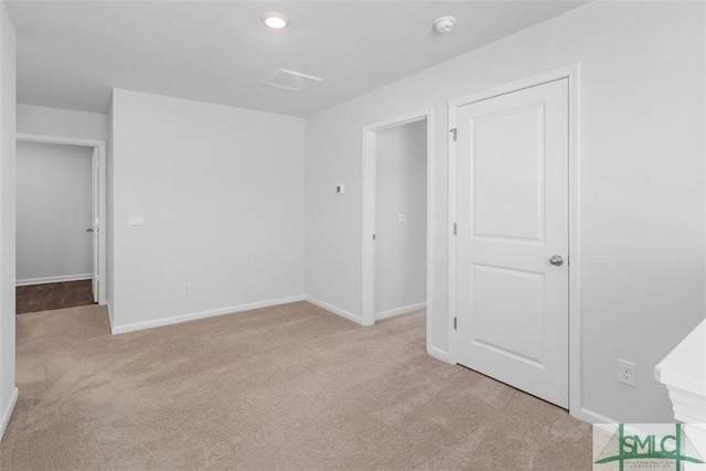 empty room featuring light carpet