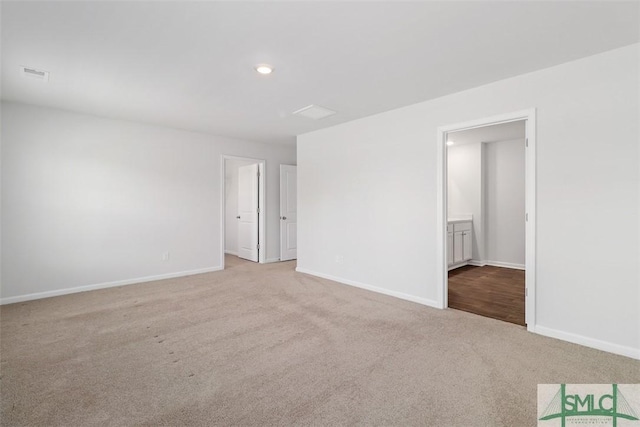 empty room featuring light colored carpet