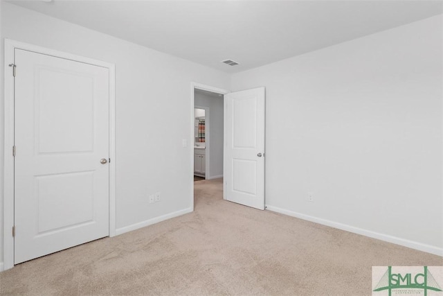 unfurnished bedroom with light colored carpet