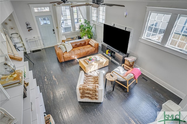 living room with dark wood-type flooring and ceiling fan