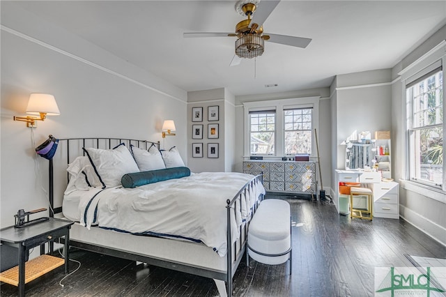 bedroom with ceiling fan and dark hardwood / wood-style flooring