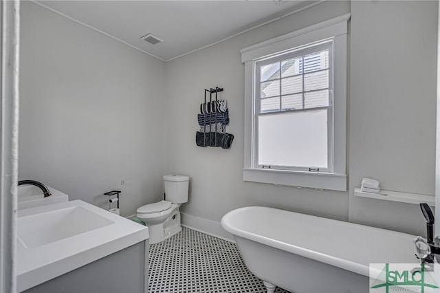 bathroom featuring vanity, a tub, and toilet