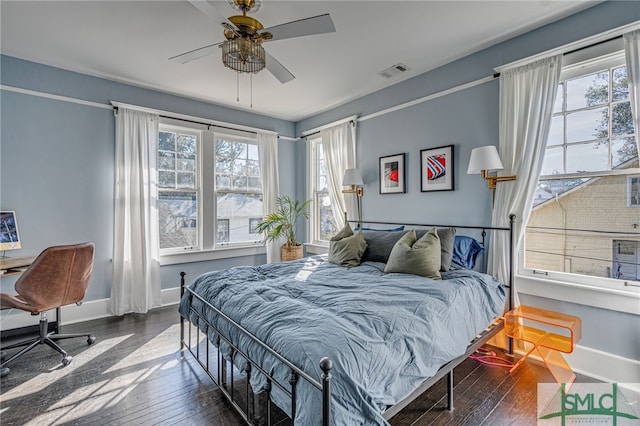 bedroom with ceiling fan and dark hardwood / wood-style flooring