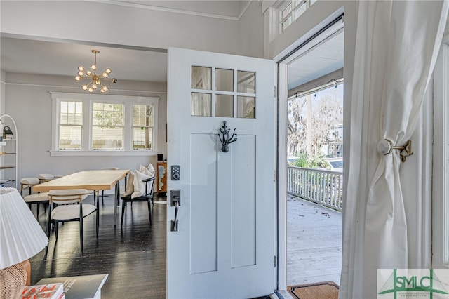 entryway featuring dark hardwood / wood-style floors and a notable chandelier