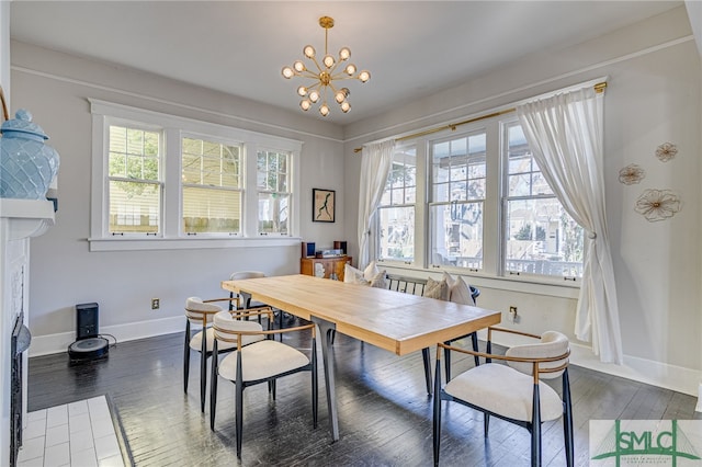 dining area with dark hardwood / wood-style floors and a notable chandelier