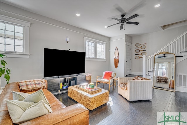 living room with ceiling fan and dark hardwood / wood-style flooring