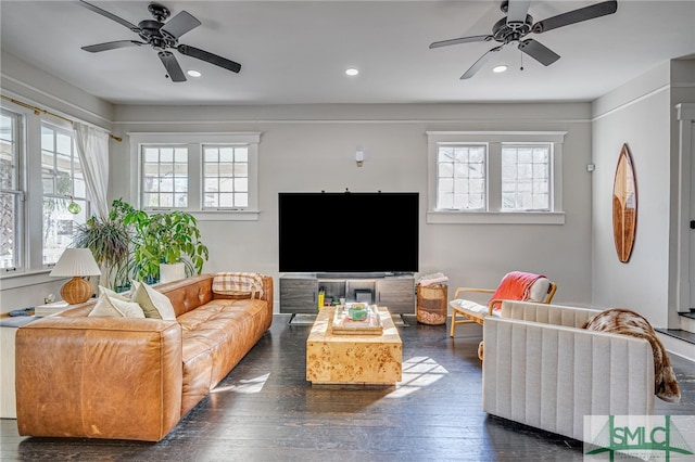 living room featuring ceiling fan and dark hardwood / wood-style flooring