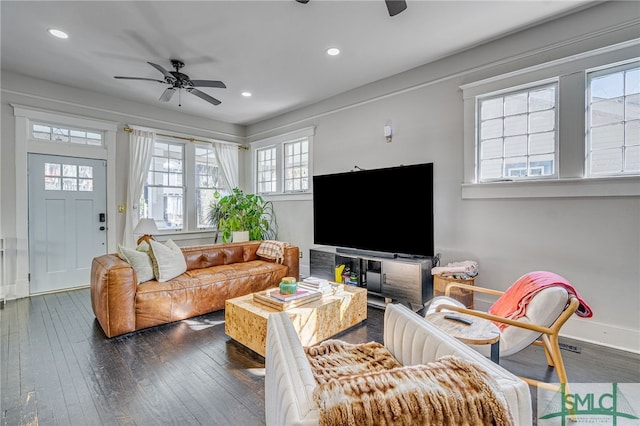 living room with ceiling fan and dark hardwood / wood-style floors