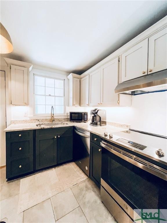 kitchen featuring sink, light tile patterned floors, white cabinets, and appliances with stainless steel finishes