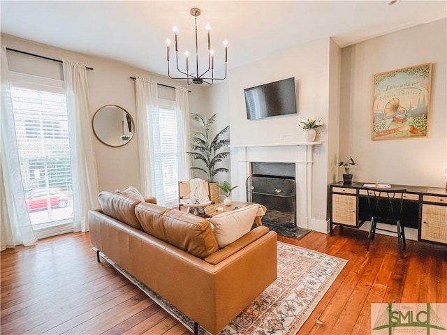 living room featuring wood-type flooring and a chandelier