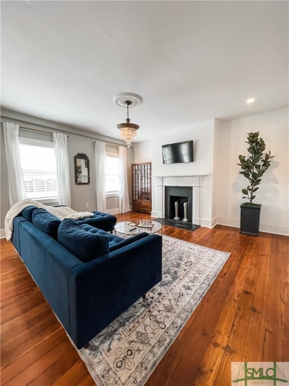 living room with wood-type flooring and a chandelier