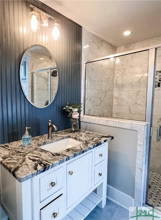 bathroom with vanity and a shower with shower door