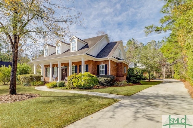 view of front of property with a front yard and covered porch