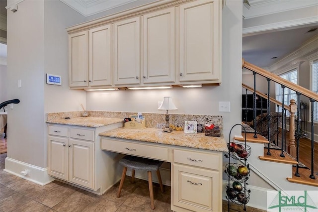 kitchen featuring light stone counters and cream cabinets