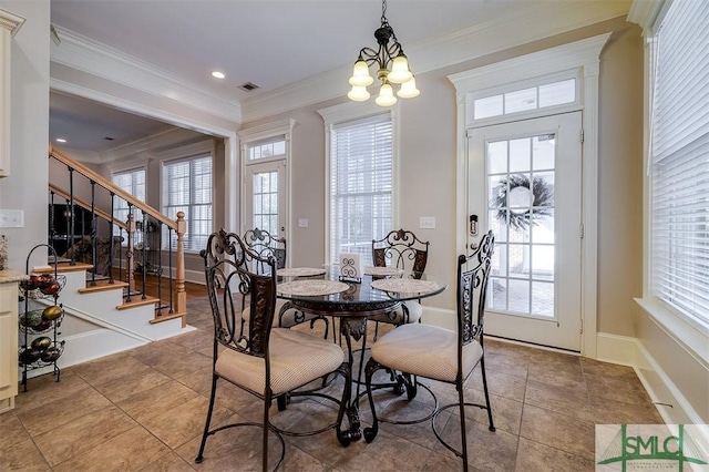 dining space featuring ornamental molding, a wealth of natural light, a notable chandelier, and light tile patterned floors