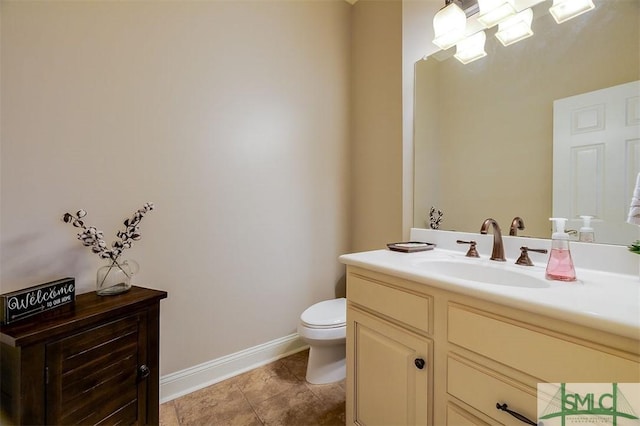 bathroom with vanity, tile patterned flooring, and toilet