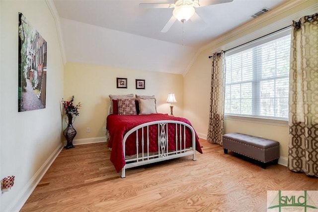 bedroom with ceiling fan, lofted ceiling, and hardwood / wood-style floors