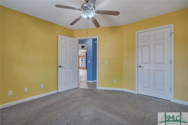 unfurnished bedroom featuring ceiling fan and light carpet