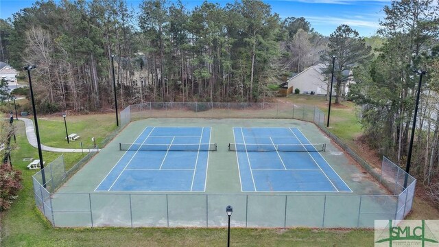 view of sport court featuring a lawn