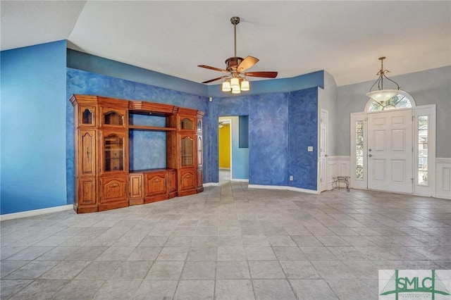 unfurnished living room featuring lofted ceiling and ceiling fan