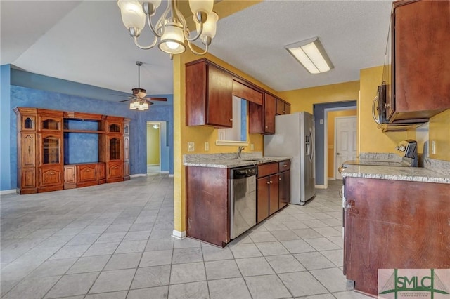 kitchen with light tile patterned flooring, appliances with stainless steel finishes, ceiling fan with notable chandelier, decorative light fixtures, and light stone counters