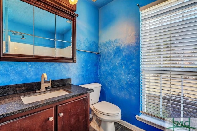 bathroom with vanity, a wealth of natural light, and toilet