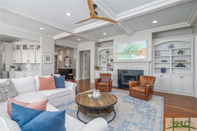 living room with coffered ceiling, beam ceiling, crown molding, hardwood / wood-style flooring, and a fireplace