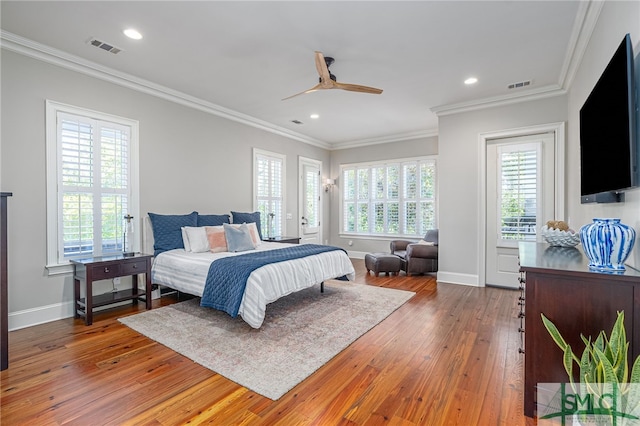 bedroom with ornamental molding, wood-type flooring, and ceiling fan