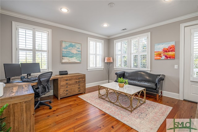 home office with hardwood / wood-style flooring, crown molding, and a wealth of natural light