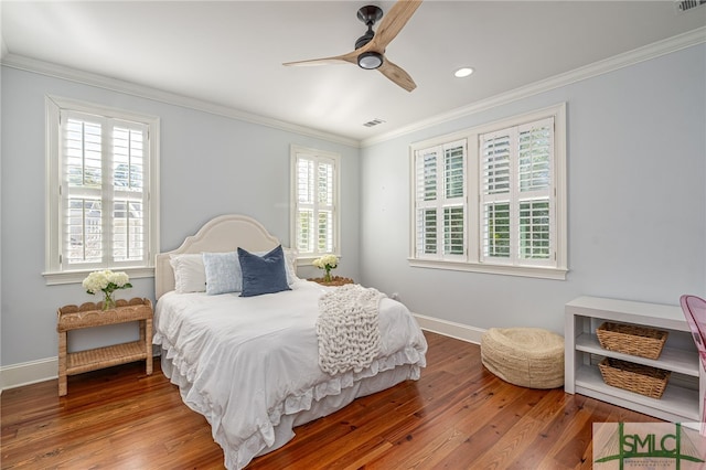 bedroom with ceiling fan, ornamental molding, and hardwood / wood-style floors