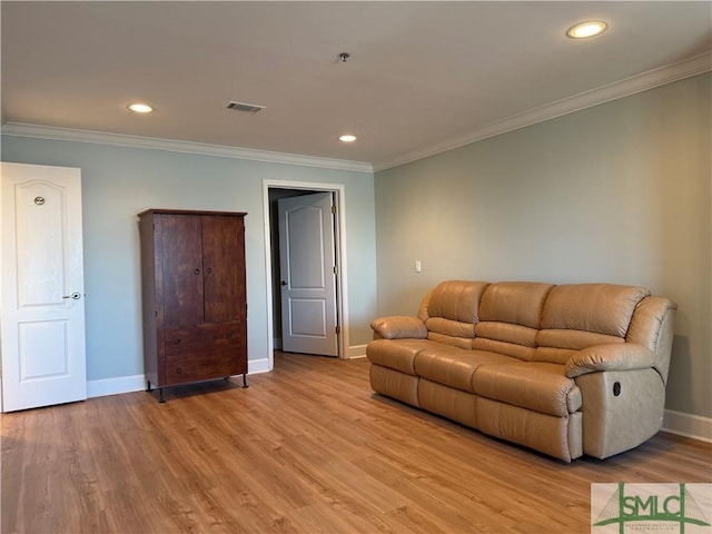 living room featuring ornamental molding and light wood-type flooring