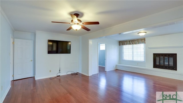 unfurnished living room featuring hardwood / wood-style floors, crown molding, and ceiling fan