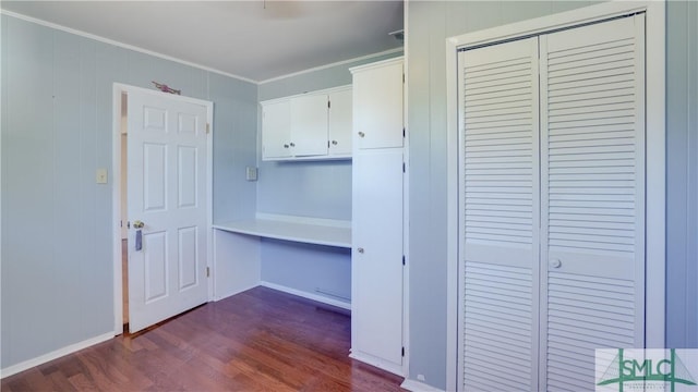 interior space featuring crown molding and dark hardwood / wood-style floors