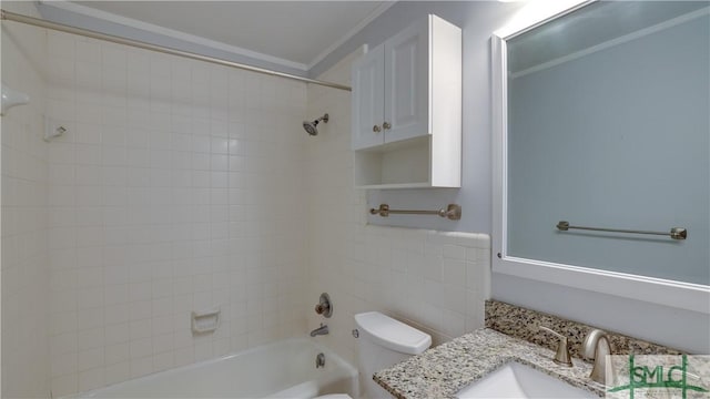 full bathroom featuring tiled shower / bath, ornamental molding, toilet, and vanity