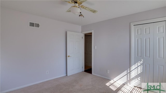 unfurnished room with light colored carpet and ceiling fan