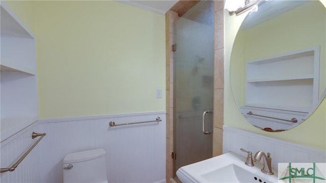 bathroom with an enclosed shower, sink, and toilet