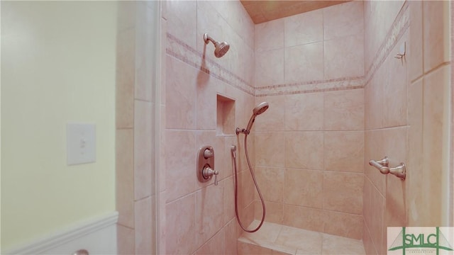 bathroom with tiled shower