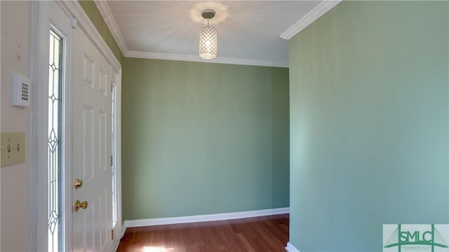 entrance foyer featuring ornamental molding and dark hardwood / wood-style floors