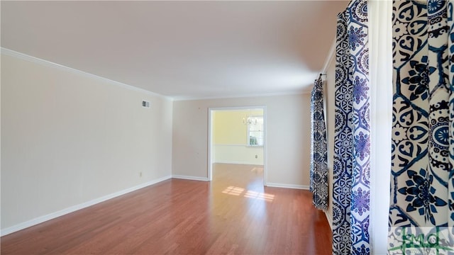 unfurnished room with crown molding and hardwood / wood-style floors