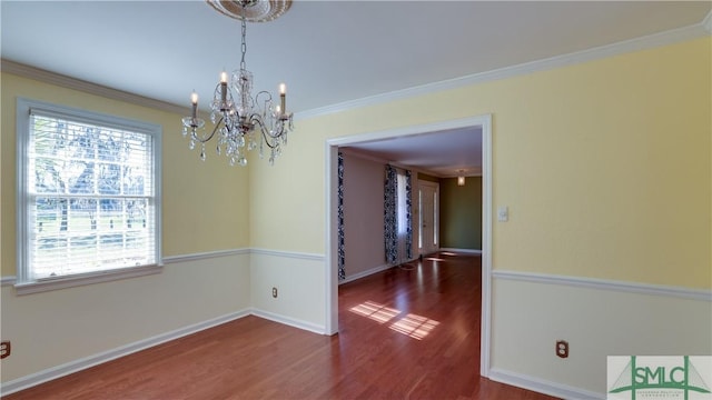 unfurnished dining area featuring crown molding, dark hardwood / wood-style floors, and a notable chandelier