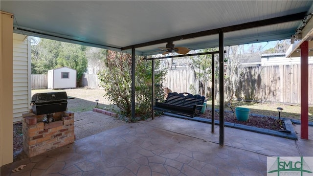 view of patio / terrace featuring a shed, grilling area, and ceiling fan