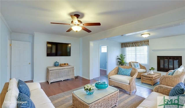 living room featuring crown molding, ceiling fan, and light hardwood / wood-style floors