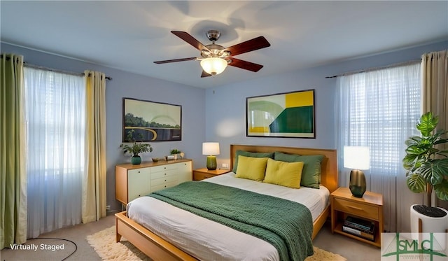 carpeted bedroom with ceiling fan