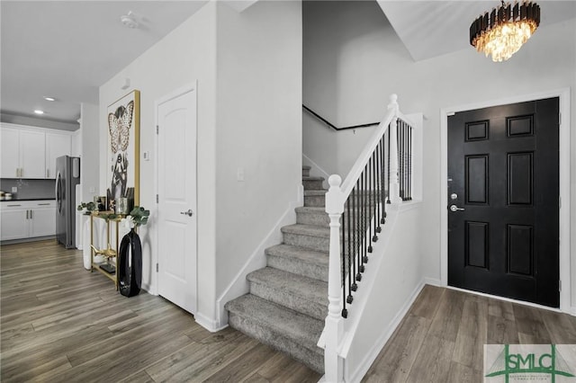 foyer featuring a notable chandelier and wood-type flooring