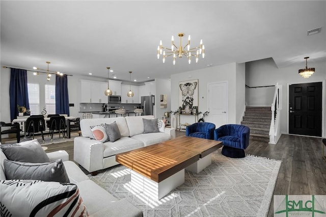 living room featuring wood-type flooring and a notable chandelier