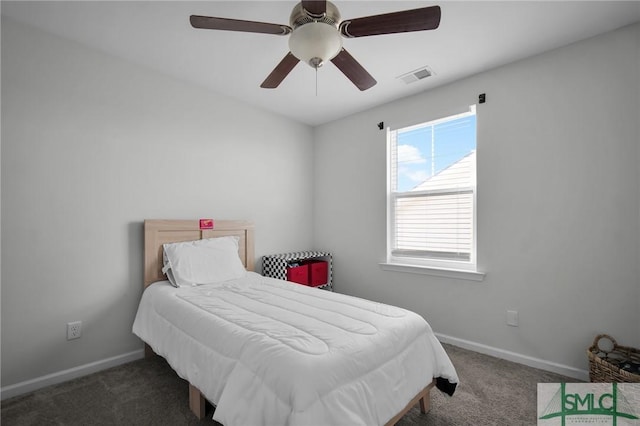 bedroom featuring dark colored carpet and ceiling fan