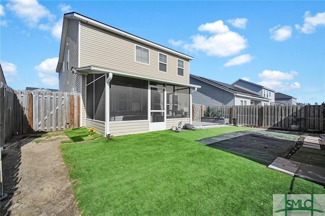 rear view of property with a sunroom, a lawn, and a patio area